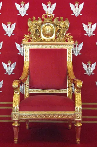 throne: an impressive seat used by a monarch, often on a raised dais in a throne room and reserved for...