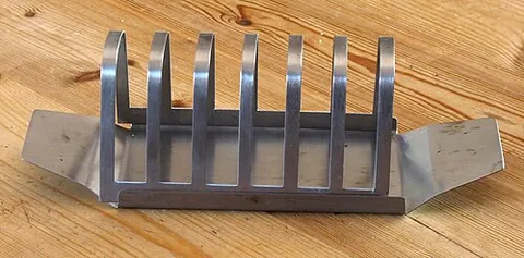 toast rack: a rack designed to hold toasted bread, with a partition for each slice