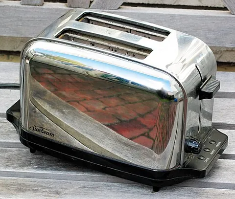 toaster: an electrical device for toasting food, typically sliced bread