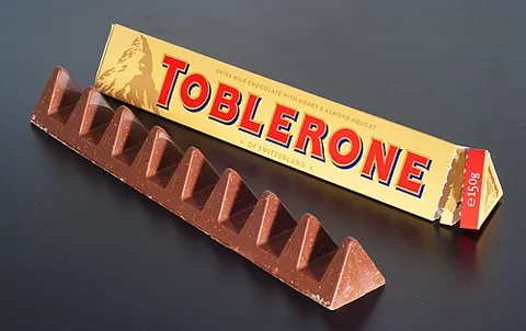 toblerone: a Swiss chocolate bar with honey, nougat and almonds, shaped like a triangular prism with...