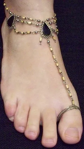 toe ring: a round piece of metal worn around the toe