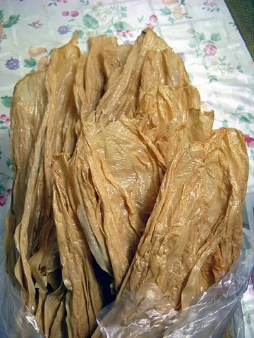 tofu skin: a food product made from soybeans in the form of a thin, yellow sheet used in Chinese and Japanese...