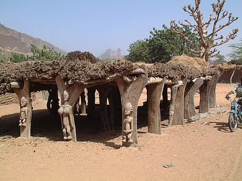 toguna: a public building erected by the Dogon people of Mali, having a low roof to force visitors to sit...