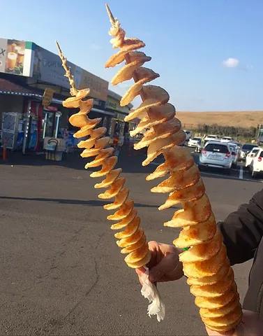 tornado potato: a potato sliced thinly into a screw shape around a skewer and deep-fried