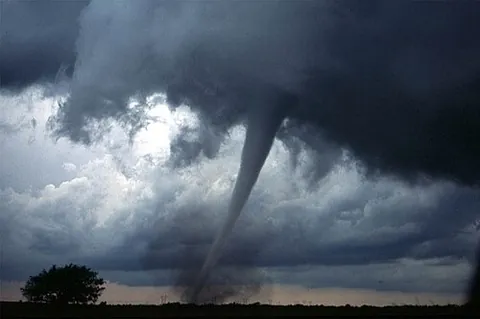 tornado: a violent wind in the form of a mobile, rapidly rotating, funnel cloud that has contacted the ground