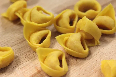 tortellini: a kind of small, ring-shaped pasta, stuffed with meat, cheese, etc; and eaten with a sauce or in a...