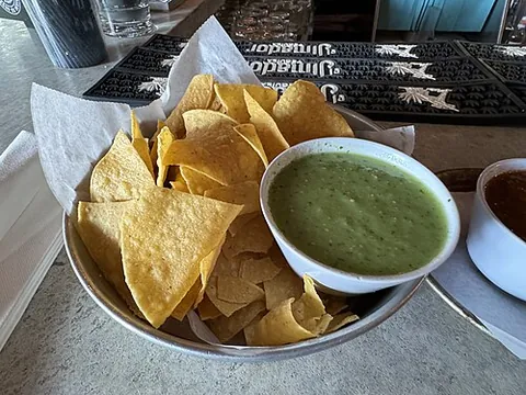 tortilla chip: a chip or crisp made from baked corn tortillas