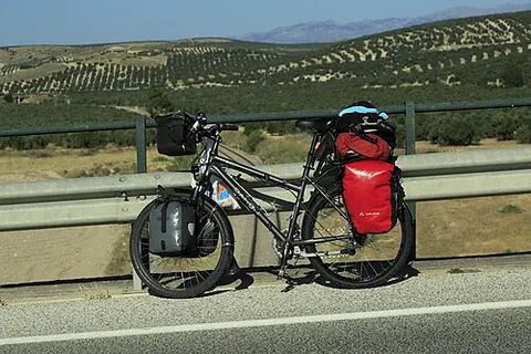 touring bicycle: a bicycle designed or modified for touring with luggage