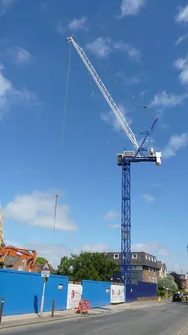 tower crane: a crane, consisting of a balanced beam erected on top of a tall metal (normally self-erecting)...