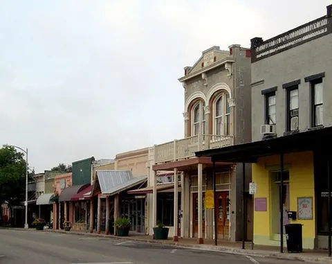 town: a settlement; an area with residential districts, shops and amenities, and its own local...