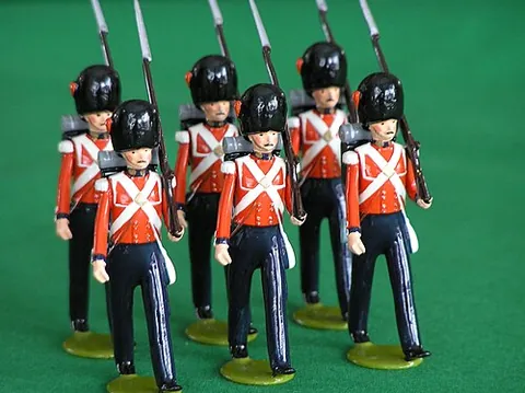 toy soldier: a figurine created to resemble a miniature of a person outfitted for military combat