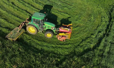 tractor: a vehicle used in farms e.g. for pulling farm equipment and preparing the fields