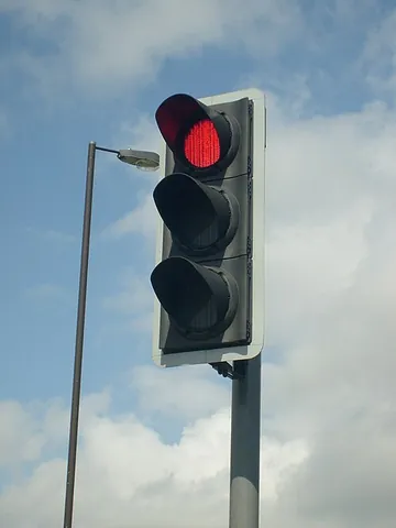 traffic light: a signalling device positioned at a road intersection or pedestrian crossing indicating the moment...