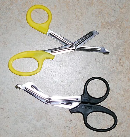 trauma shears: a kind of scissors with a bent blade, used by paramedics etc. to cut clothing quickly and safely...