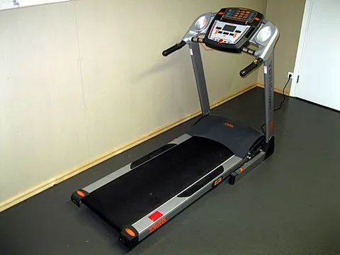 treadmill: a piece of indoor sporting equipment used to allow for the motions of running or walking while...