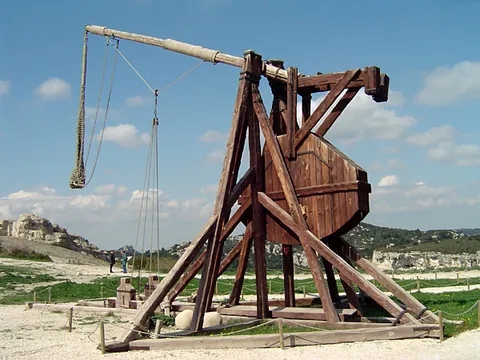 trebuchet: a medieval siege engine consisting of a large pivoting arm heavily weighted on one end