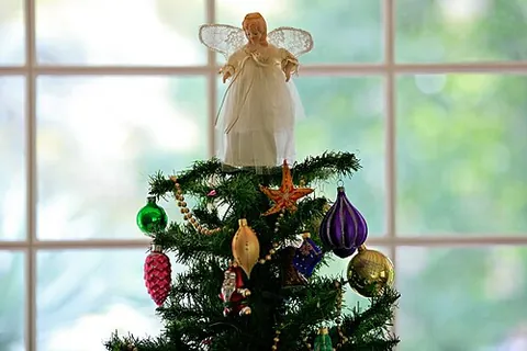 tree topper: a decorative ornament placed on the top of a Christmas tree, often in the form of a star or angel