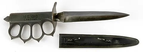 trench knife: a knife designed for use in hand-to-hand fighting in trenches, typically having a double-edged...