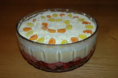 trifle: an English dessert made from a mixture of thick custard, fruit, sponge cake, jelly and whipped cream