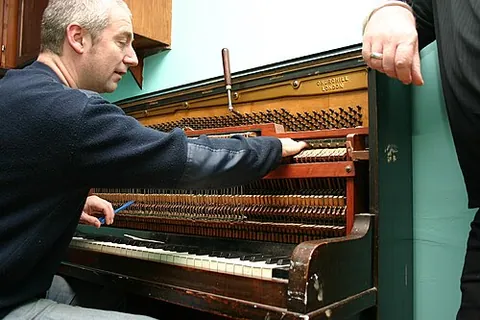 tuner: a person who tunes a piano or organ