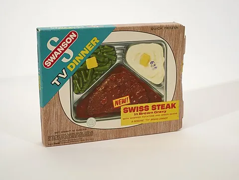 tv dinner: a prepackaged meal purchased chilled or frozen and heated at home