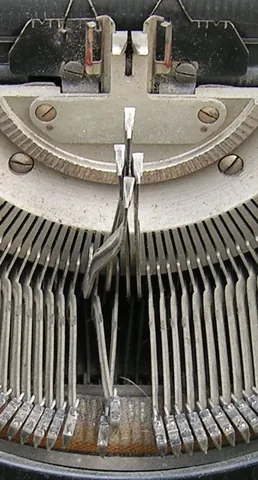 typebar: in some typewriters, an arm actuated by pressing the keys that carried the type to strike the...