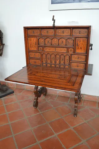 vargueno: a decorative cabinet of a kind originating near Toledo in Spain, having a rectangular body...