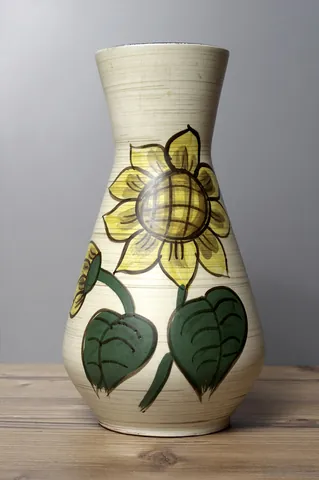 vase: an upright open container used mainly for displaying fresh, dried, or artificial flowers