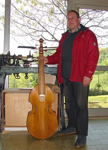 viol: a stringed instrument related to the violin family, but held in the lap between the legs like a...