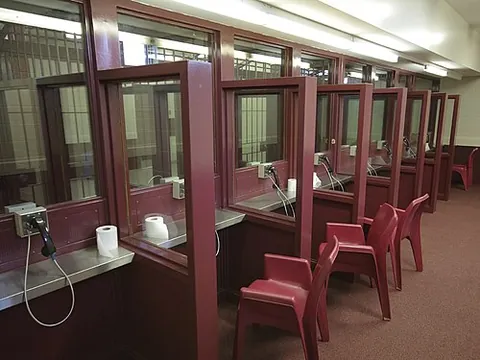 visiting room: a room in a prison where inmates and visitors can interact, sometimes with a screen separating them