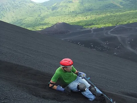 volcano boarding: a sport resembling snowboarding, but performed on volcanic ash on the slopes of a volcano
