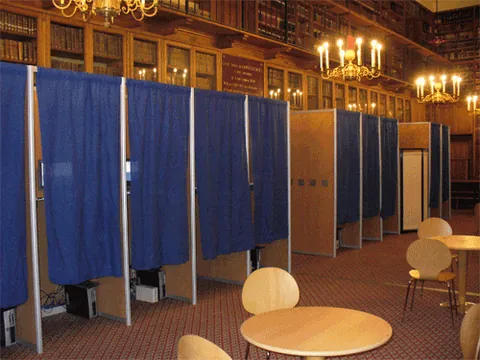 voting booth: a small enclosed compartment where a voter may register a vote in private; it may house some voting...