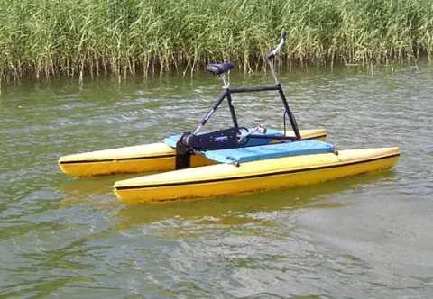 water bicycle: a bicycle frame set between a pair of pontoon floats, with the pedals connected to a propeller and...