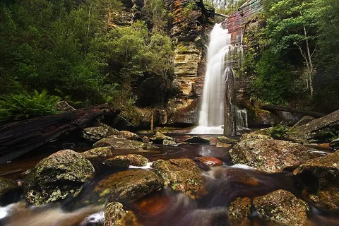 waterfall: a flow of water over the edge of a cliff