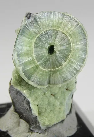 wavellite: a hydrated aluminium phosphate, Al₃(PO₄)₂(OH,F)₃·5H₂O, sometimes mined as a source of phosphorus