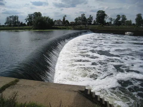 weir: an adjustable dam placed across a river to regulate the flow of water downstream