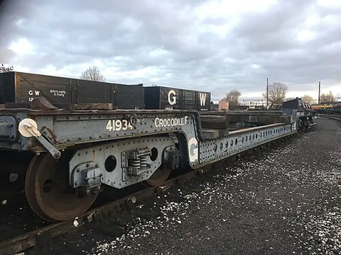 well wagon: an open goods wagon with a well (depressed loadbed) between the bogies or axles
