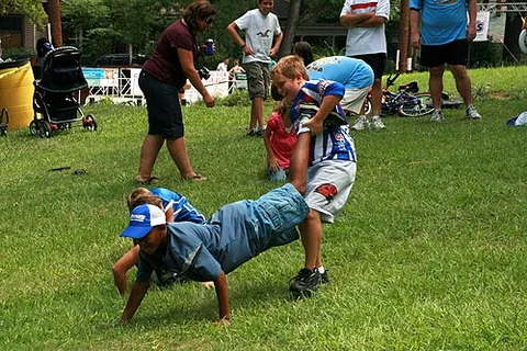 wheelbarrow race: a two-member team race in which one team member holds the legs of the other, as if the handles of a...