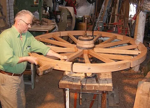 wheelwright: a person who builds and repairs wheels, especially wooden spoked ones