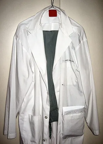 white coat: a white, knee-length coat worn by laboratory workers etc. as protection