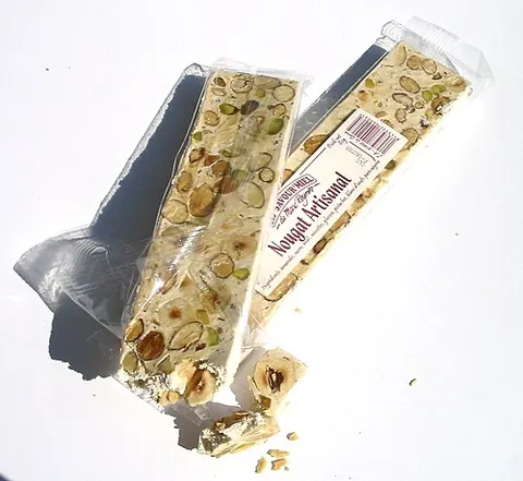 white nougat: a confection made with honey, egg whites and roasted nuts, usually hazelnut or pistachio