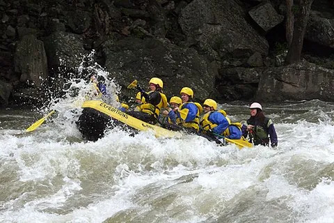 whitewater rafting: traveling by raft through a section of a river which is churning with rapids, as for sport or...