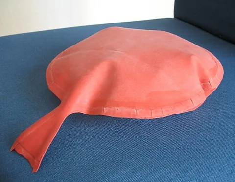 whoopee cushion: an inflatable bag containing a valve at its neck that retains the air in the bag until pressure is...