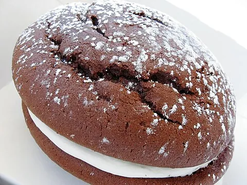 whoopie pie: a baked good consisting of two round, mound-shaped pieces of cake (typically chocolate cake) with a...
