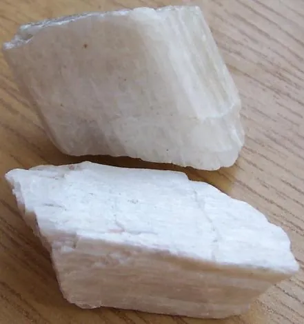 wollastonite: a grey inosilicate mineral, mostly calcium silicate, CaSiO₃, found deposited in limestone