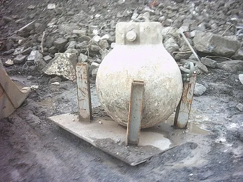 wrecking ball: a heavy steel ball, usually hung from a crane, that is swung to demolish large structures