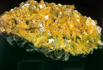 wulfenite: an orange mineral, lead molybdate, PbMoO₄, found in lead veins