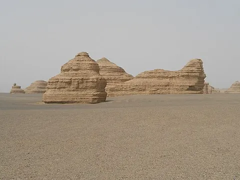 yardang: a large wind-eroded mass of soft or poorly consolidated rock in a desert region which lies parallel...