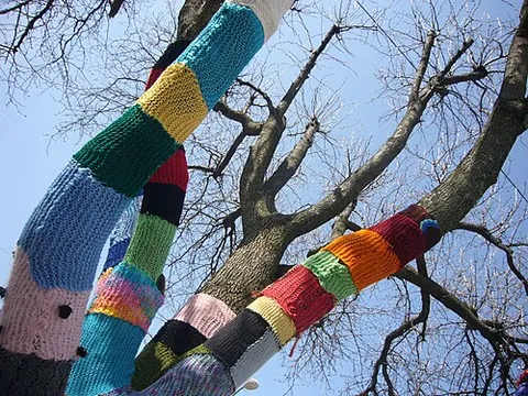 yarn bombing: a form of graffiti or street art which involves colourful displays of knitted or crocheted yarn