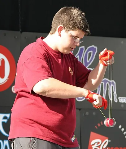 yo-yo: a toy consisting of a spheroidal or cylindrical spindle having a circular groove in which string is...